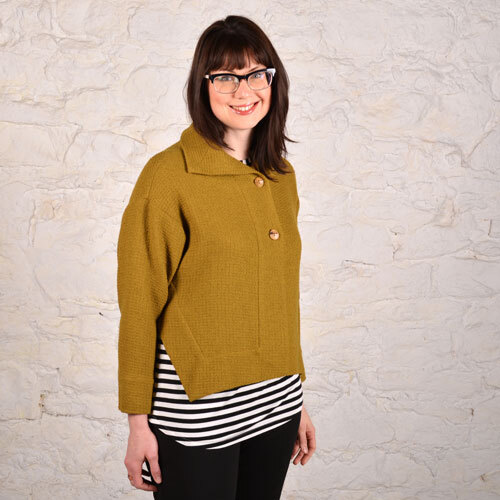 Side view of the Era Jacket made in an old gold wool boucle, worn over a black and white stripe eTee. 