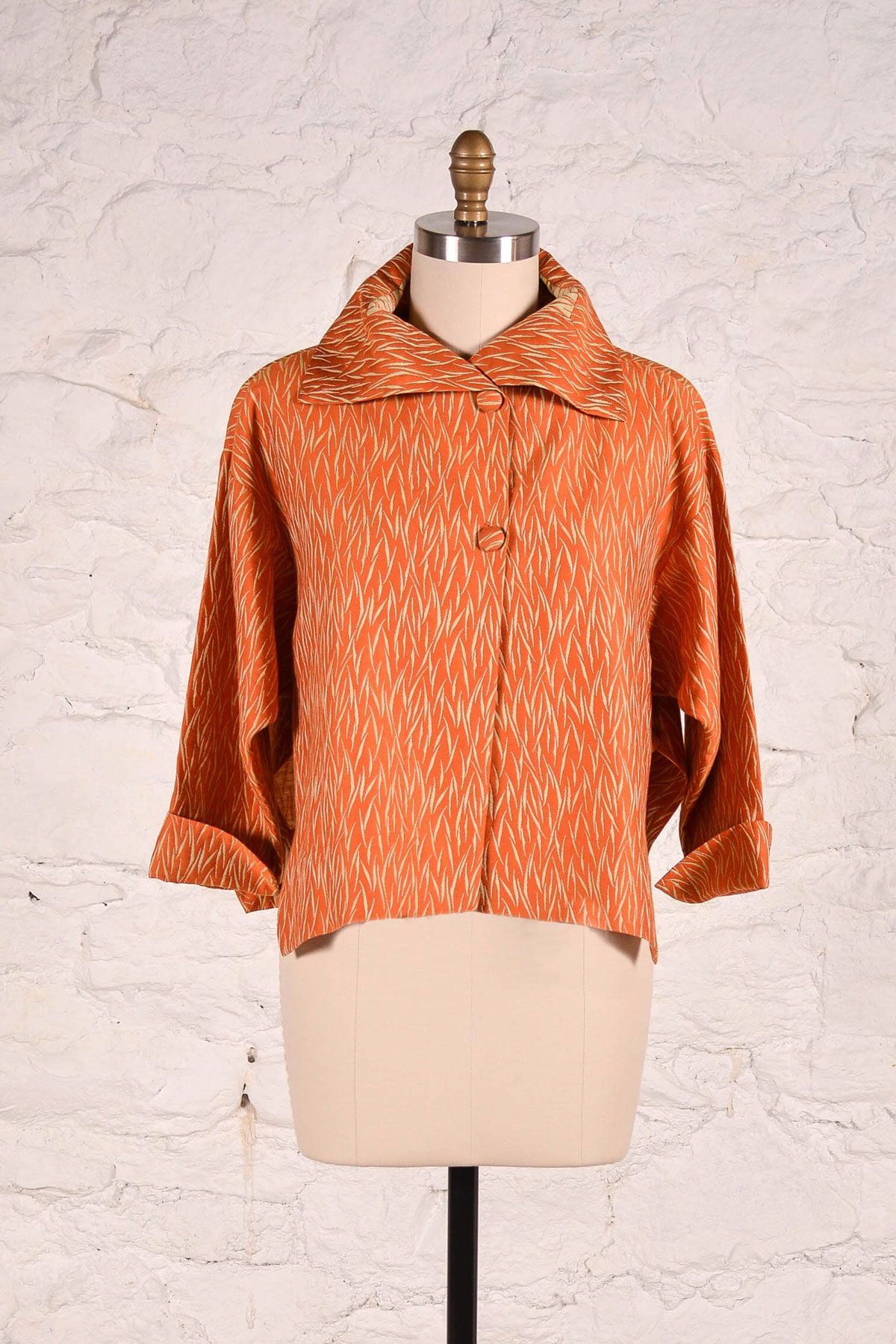The Era Jacket made in an orange jacquard fabric. 
