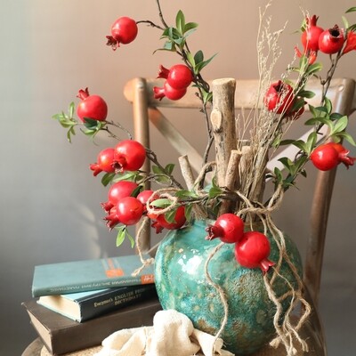 Nine-headed pomegranate branch with flowers and buds