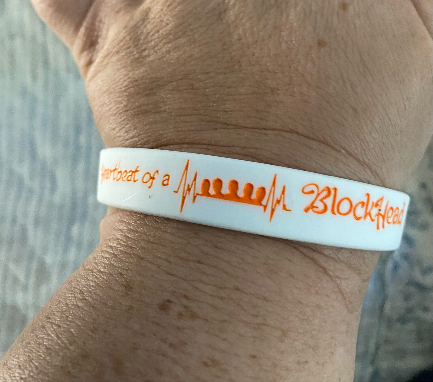 Heartbeat of a Blockhead Wristbands In White Colour &amp; Orange Text 