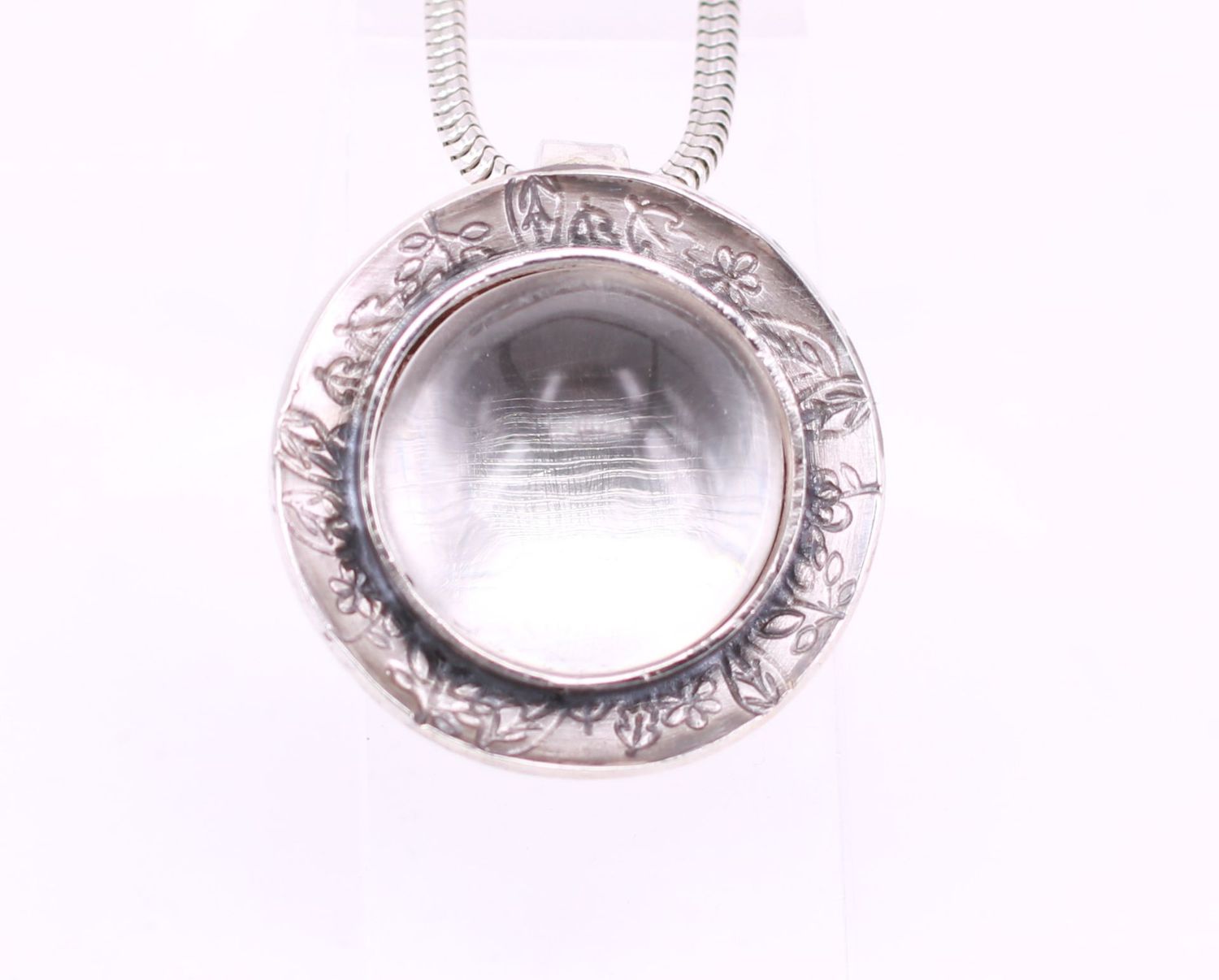 Runder Bergkristallanhänger in Schale mit Blattpunzierung Kettenanhänger für Tierhaarschmuck mit rundem Bergkristall und floraler Verzierung