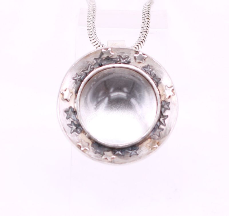 Tierhaare unter rundem Bergkristall mit Sternenschale