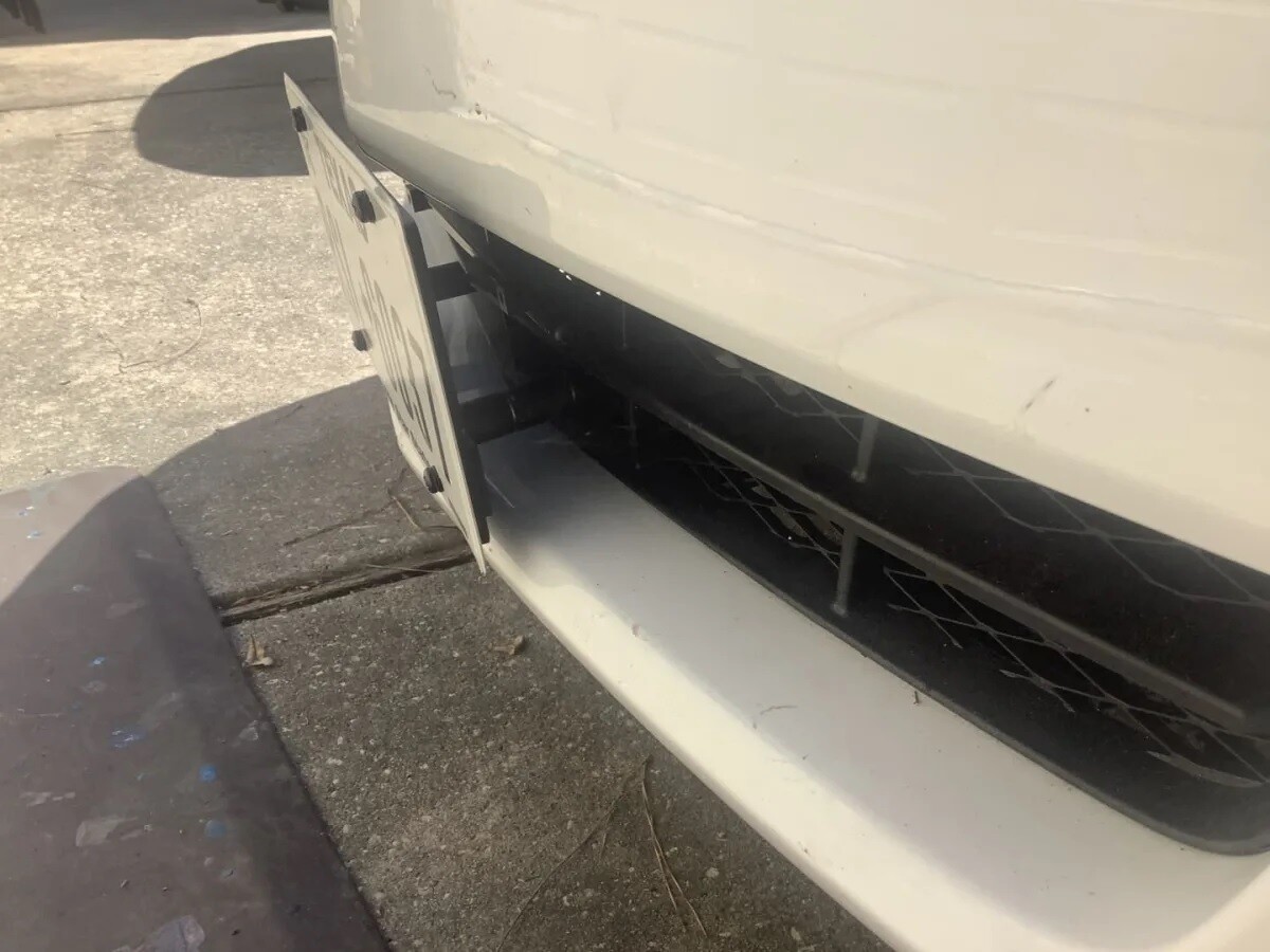 Sly Bracket for Buick Lacrosse with horizontal slats lower grille.