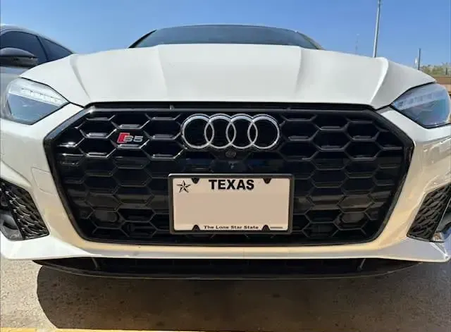 Front view of 2023 Audi S5 Sportback featuring a center-mounted, aftermarket black license plate holder from sly brackets