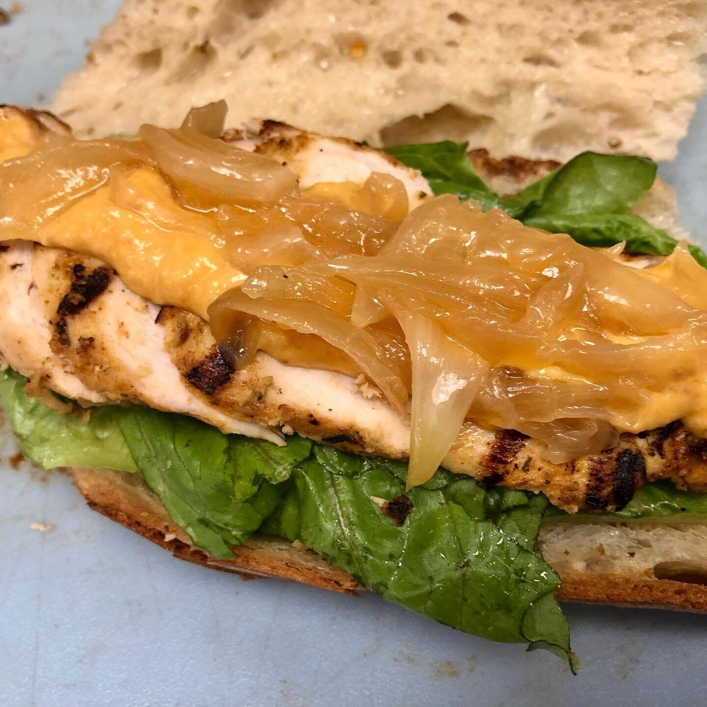 Grilled Chicken with Pee kay Aioli and Caramelized Onions on a Baguette 