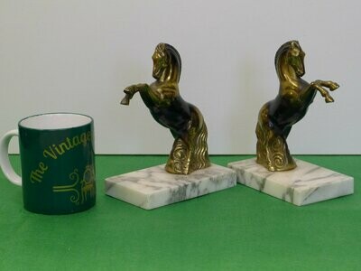Pair of French brass horses​ on marble plinths