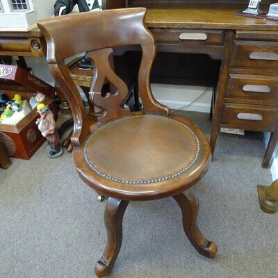 Antique Mahogany office chair with leather seat and swivel action on castors