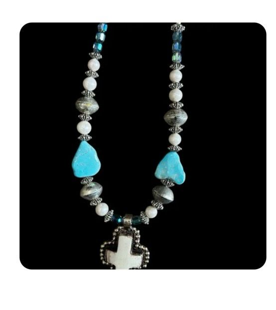 A Rare Bird Sleeping Beauty Cross Necklace