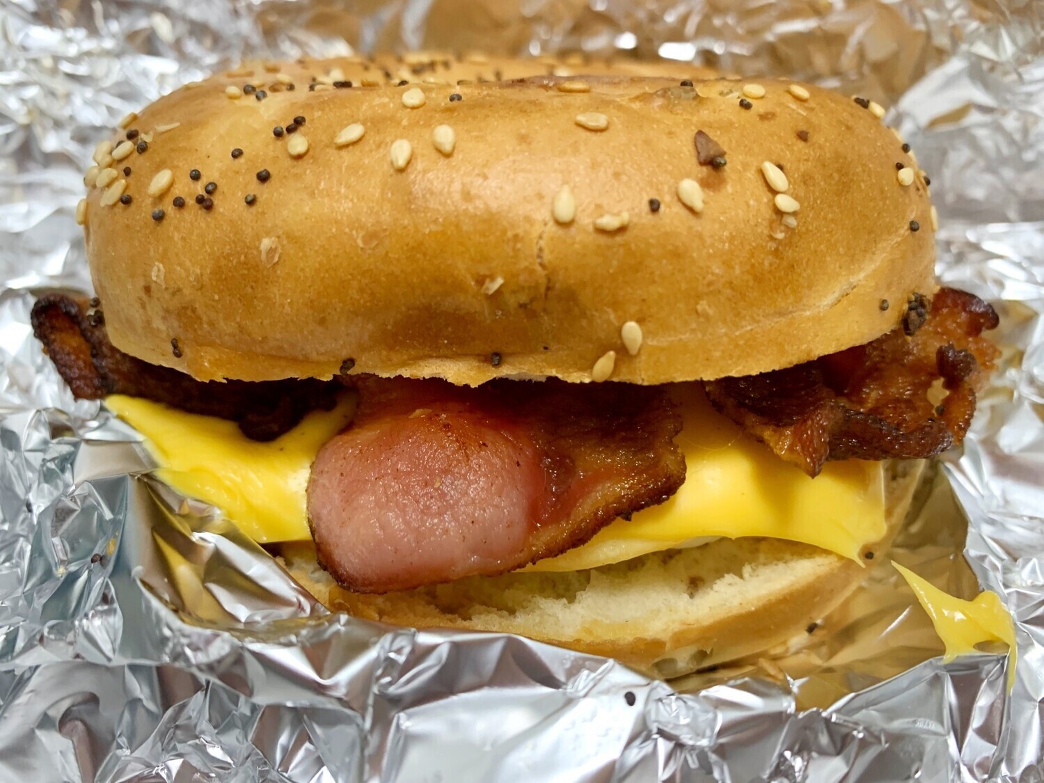 New York Bagel or "Hard" Roll, Bacon, Egg and Cheese Sandwich