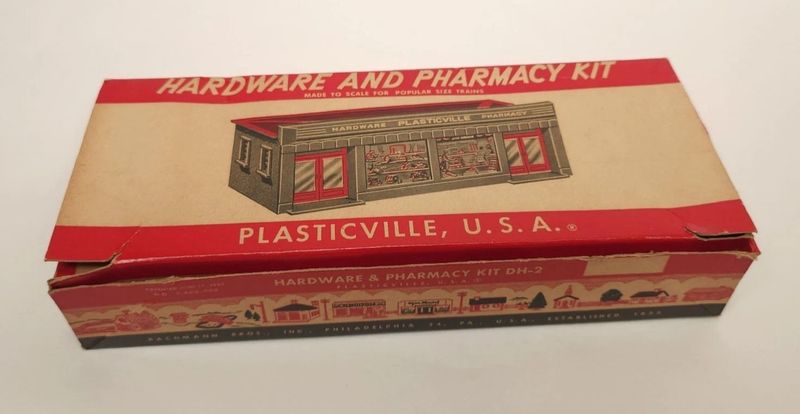 PLASTICVILLE HARDWARE & PHARMACY STORE; DH-2; beige & black; gray roof. LN, boxed. (HAVE 2) PLASTICVILLE HARDWARE & PHARMACY STORE; DH-2; beige & black; gray roof. LN, boxed. (HAVE 2)