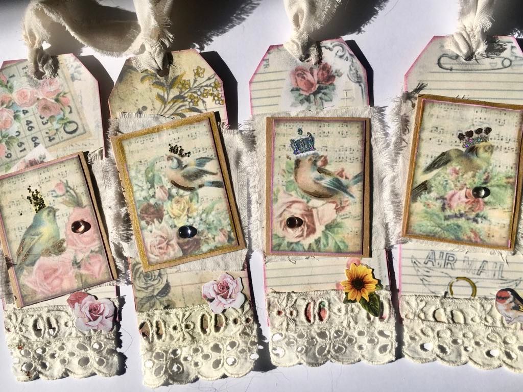 4 papercraft gift tags featuring a bird in crown motif and lace bottoms
