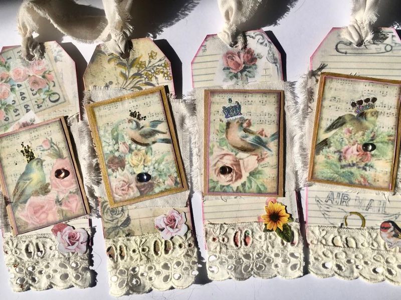4 papercraft gift tags featuring a bird in crown motif and lace bottoms
