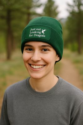 Model wearing dragon beanie outdoors in cosy autumn setting