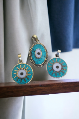 Evil eye. Silver coated brass round