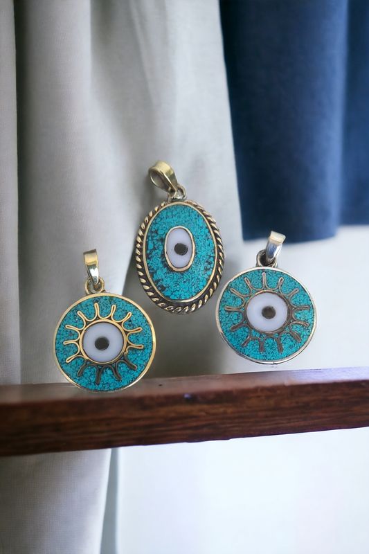 Evil eye. Silver coated brass round