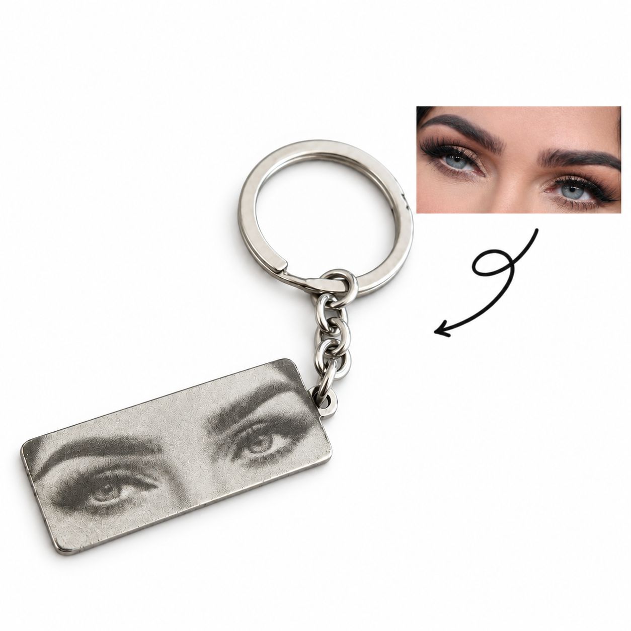 Original eye photo beside a silver-tone keyring engraved with the same eyes, with an arrow pointing to the engraving.