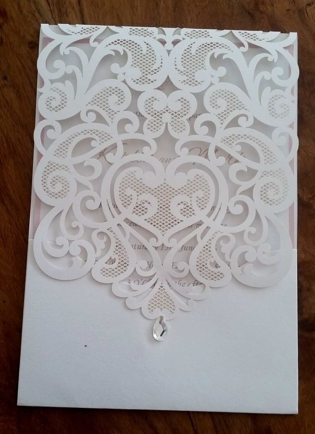 Delicate vintage lace laser cut Pocket Wedding Invitation card with diamonté drop.