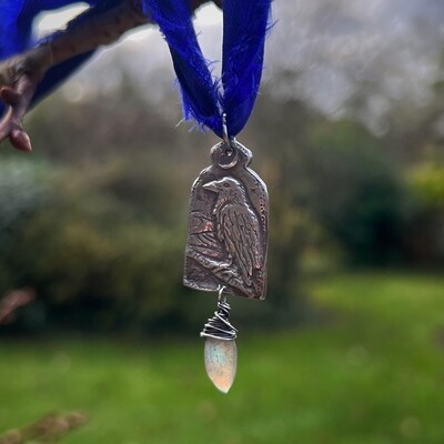 Raven in landscape ribbon pendant with Labradorite.