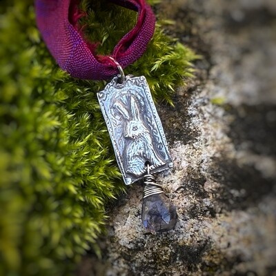 Hare on purple ribbon pendant with natural iolite.