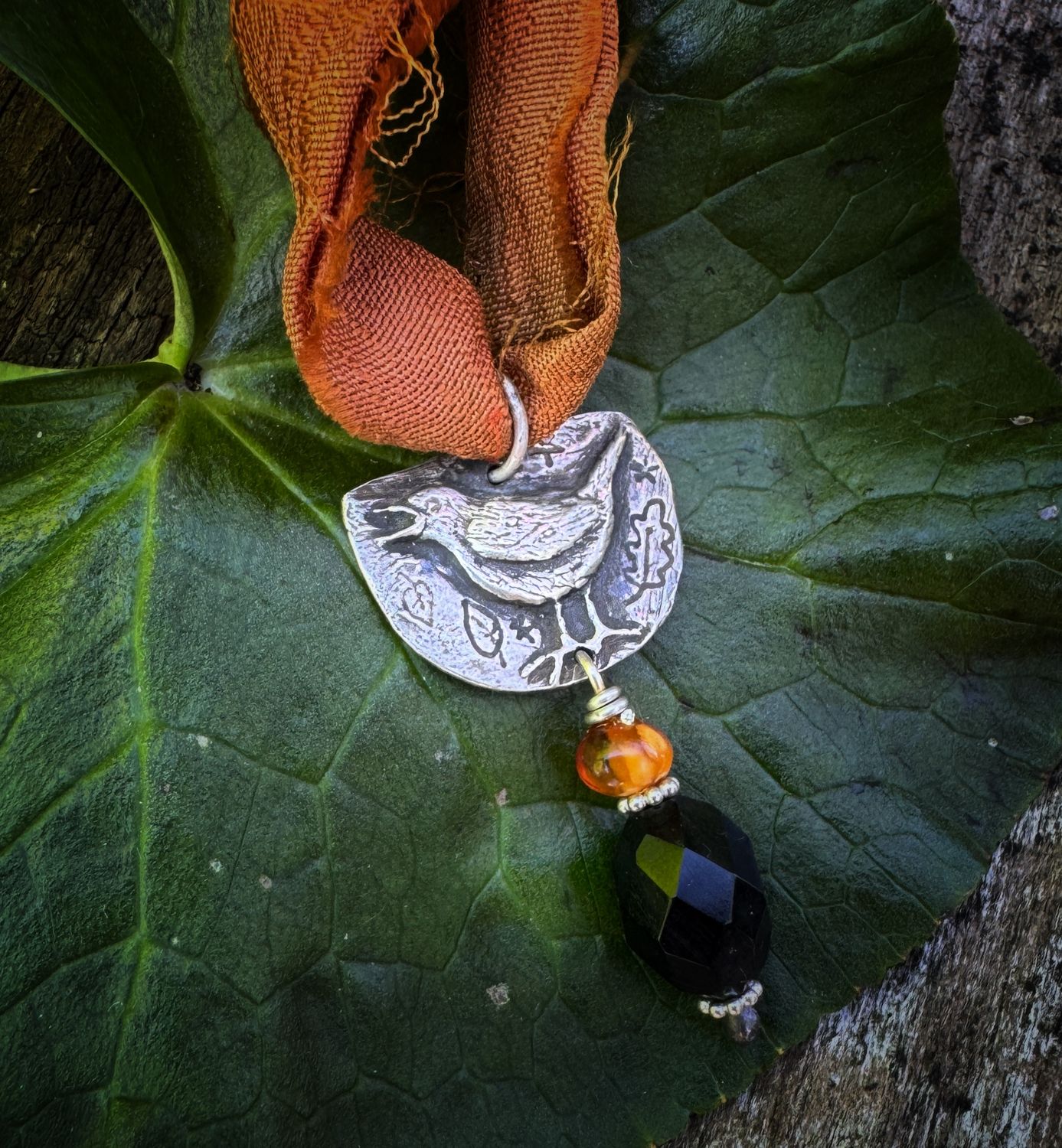 Blackbird pendant on recycled sari silk ribbon