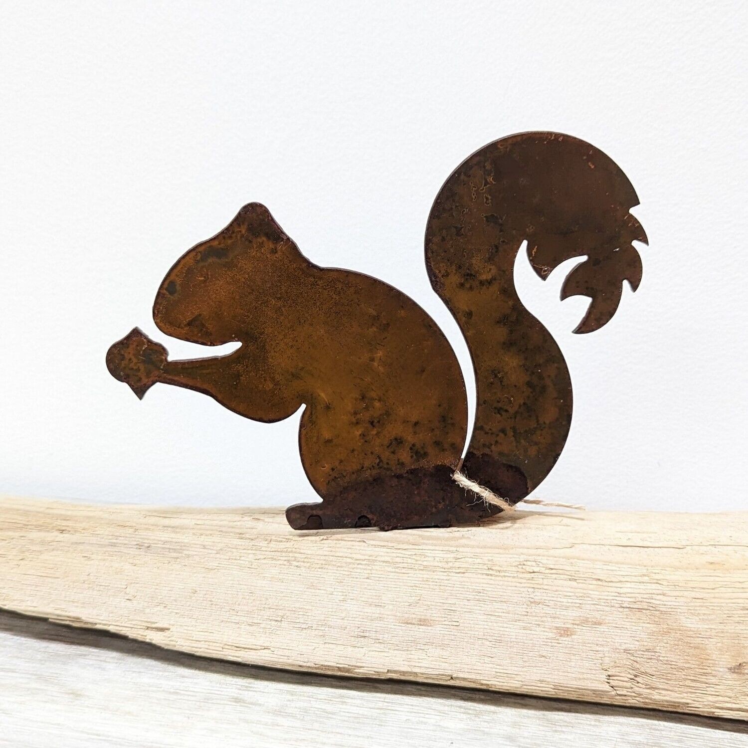 Rusted Metal Squirrel on Driftwood