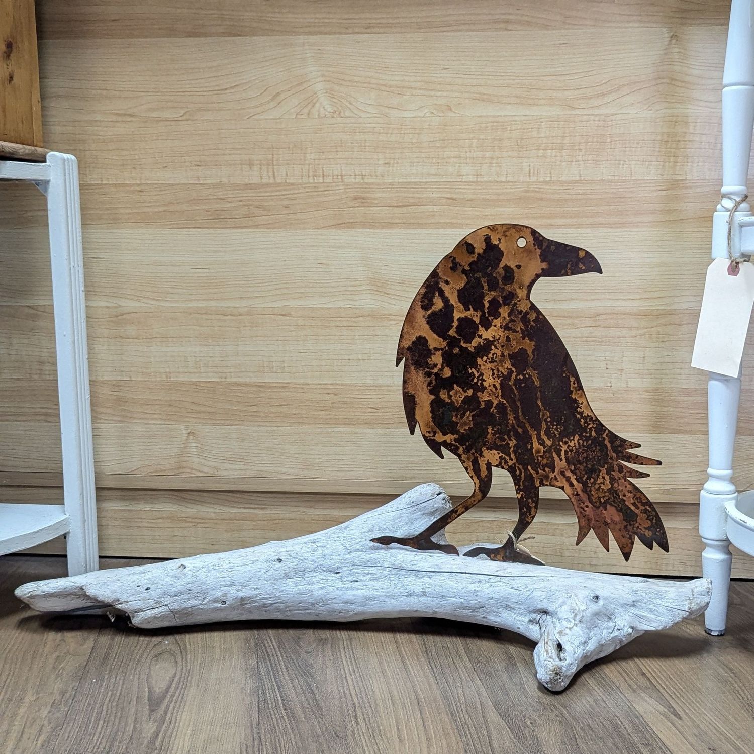 Rusted Metal Raven On Driftwood