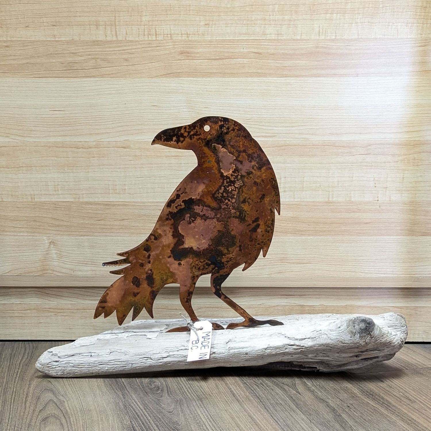 Rusted Metal Raven On Driftwood