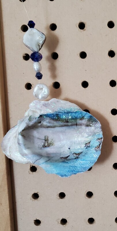 Oyster shell with the beach and sandpipers