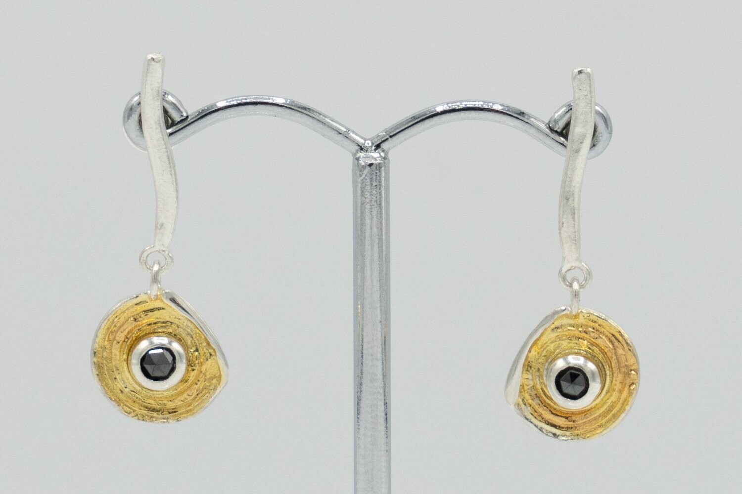 Stylish contemporary Drop earring with black Diamond detail.