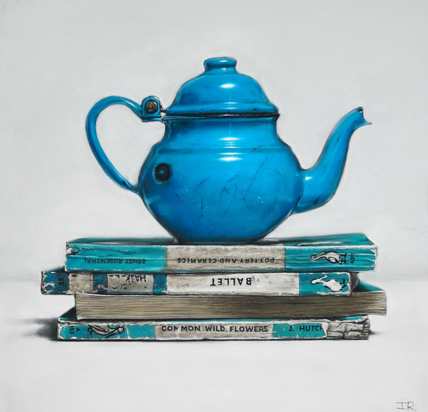 Blue tea pot and books