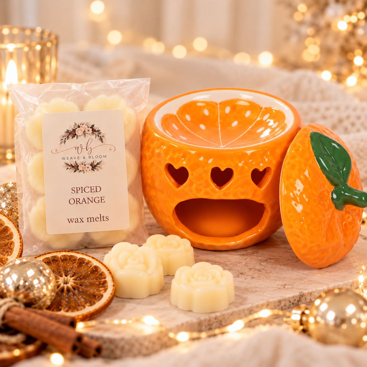 Orange Burner Orange ceramic Christmas wax melt burner with green leaf lid and heart cut-outs, displayed with Weave & Bloom Spiced Orange f