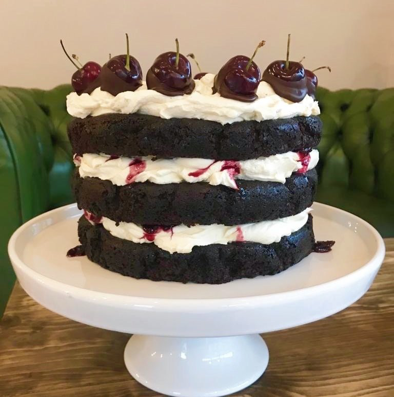 Black Forest - Classic and indulgent, layered with house made cherry jam and mascarpone cream frosting and topped with fresh cherries for a sophisticated twist on the beloved Black Forest. Fresh cherries subject to seasonal availability.