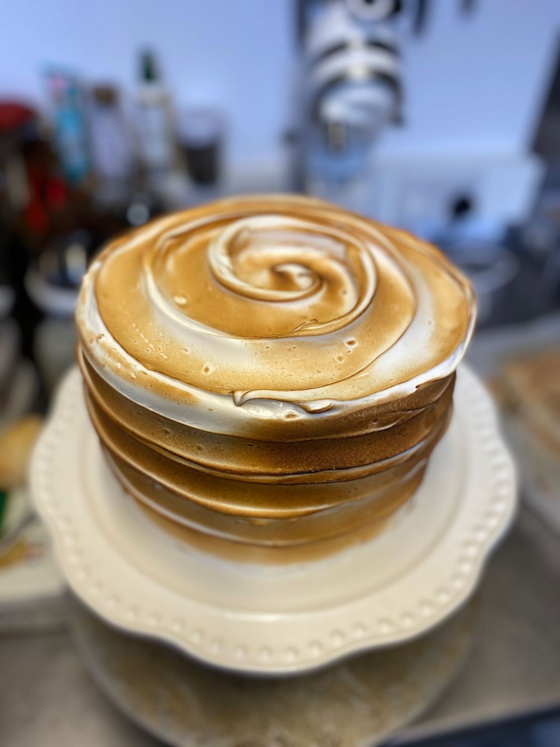 Lemon Meringue - Inspired by the classic pie, this one’s for the citrus lovers. Layers of lemon drizzle sponge filled with tangy lemon curd and lemon buttercream, then covered in soft Swiss meringue and lightly torched for that golden, marshmallowy finish.
