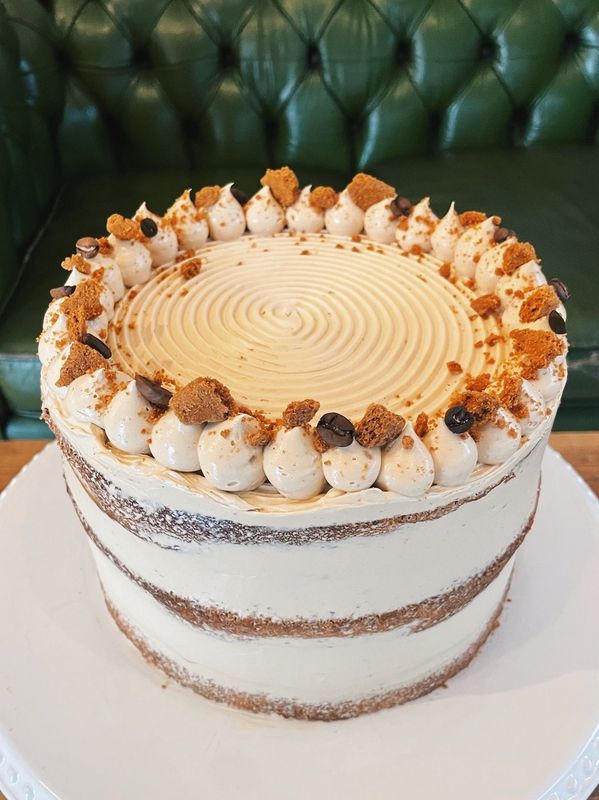 Coffee & Biscoff Cake - Spiced, sweet, and perfectly balanced — this one’s a modern favourite. Made with three layers of espresso-soaked sponge swirled with crushed Lotus biscuits, layered with Biscoff spread, and iced in a silky espresso Swiss meringue buttercream. Finished with crushed Lotus biscuits, roasted coffee beans and edible flowers. A dreamy match for coffee and Biscoff lovers alike.
