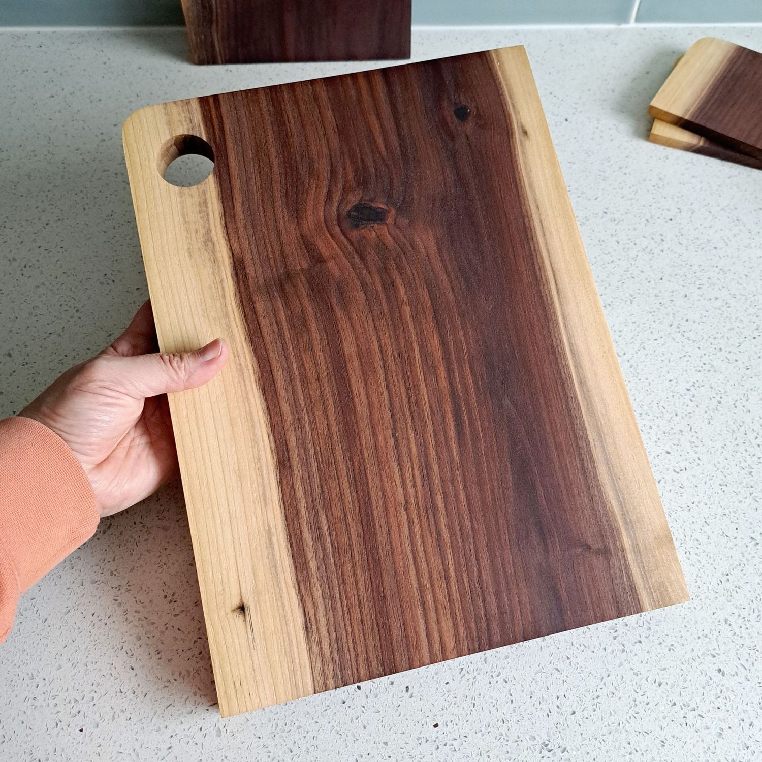 A dark brown and blond cutting board made from American black Walnut