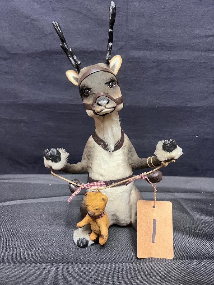 Reindeer Sitting Holding Bear