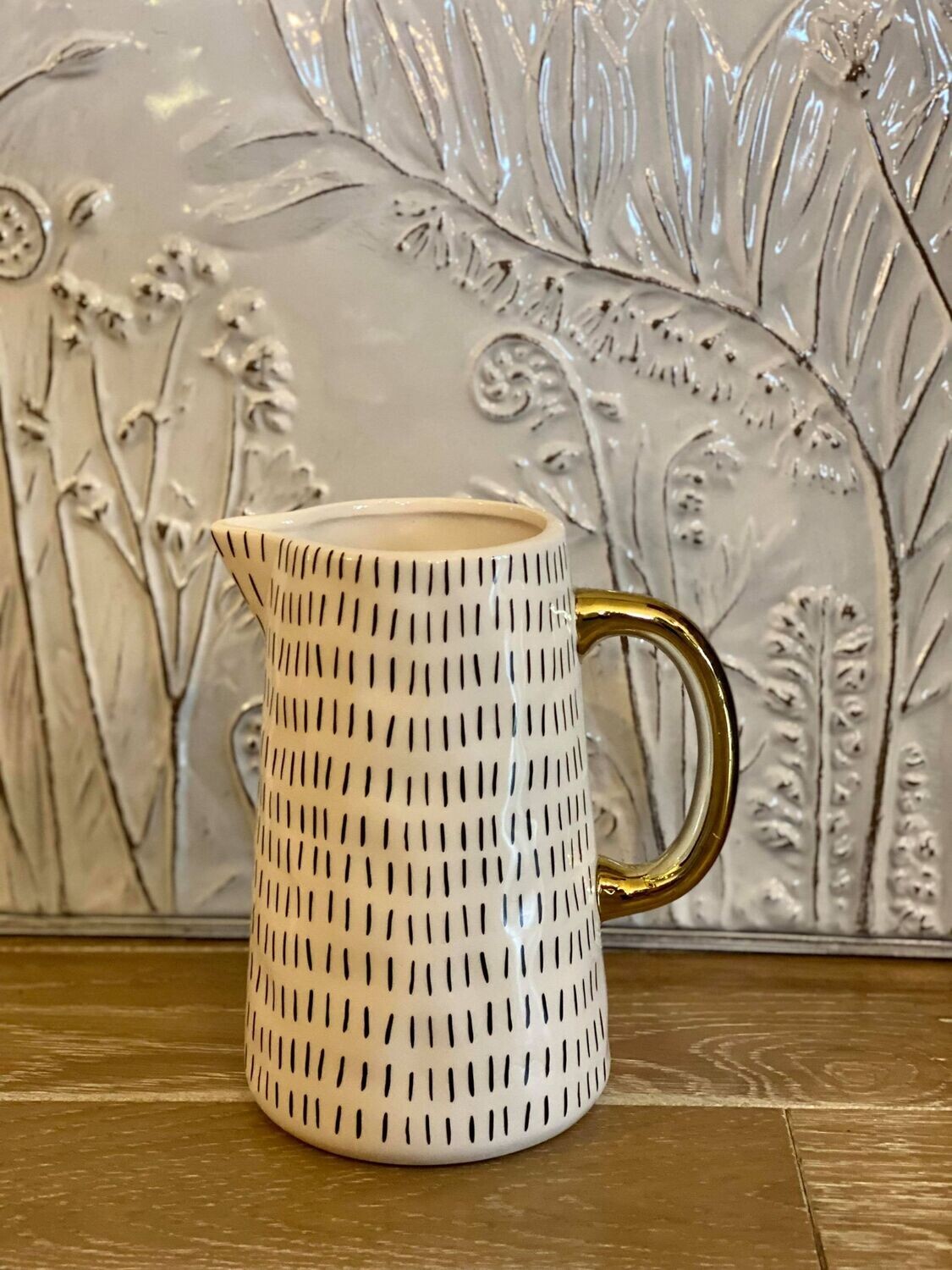 Gold and White Ceramic Pitcher with Black Details