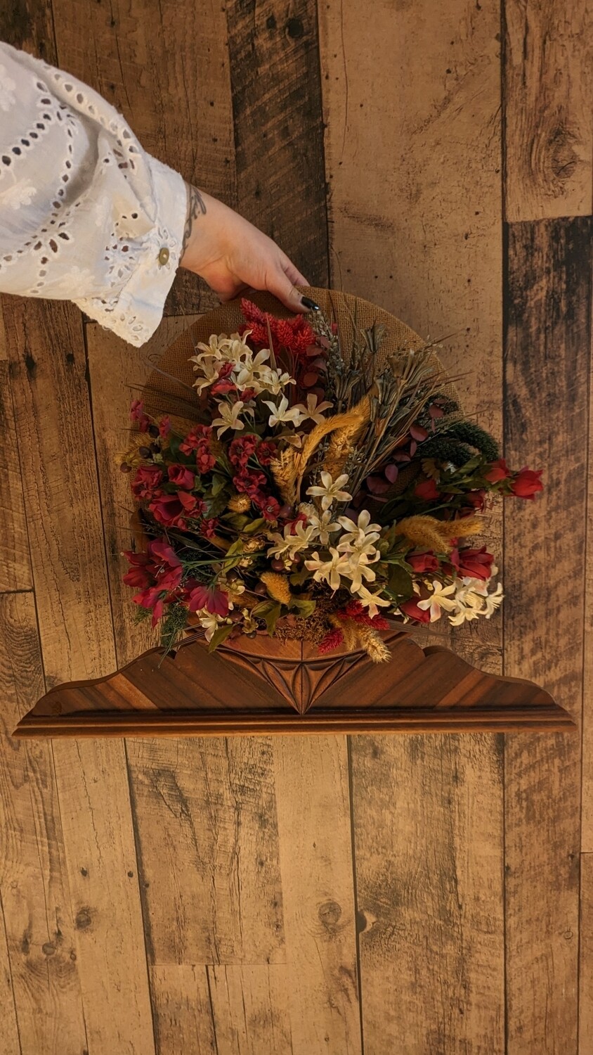 Floral arrangement on wood base