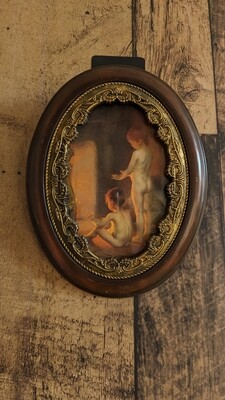 Oval frame with brass ornamental