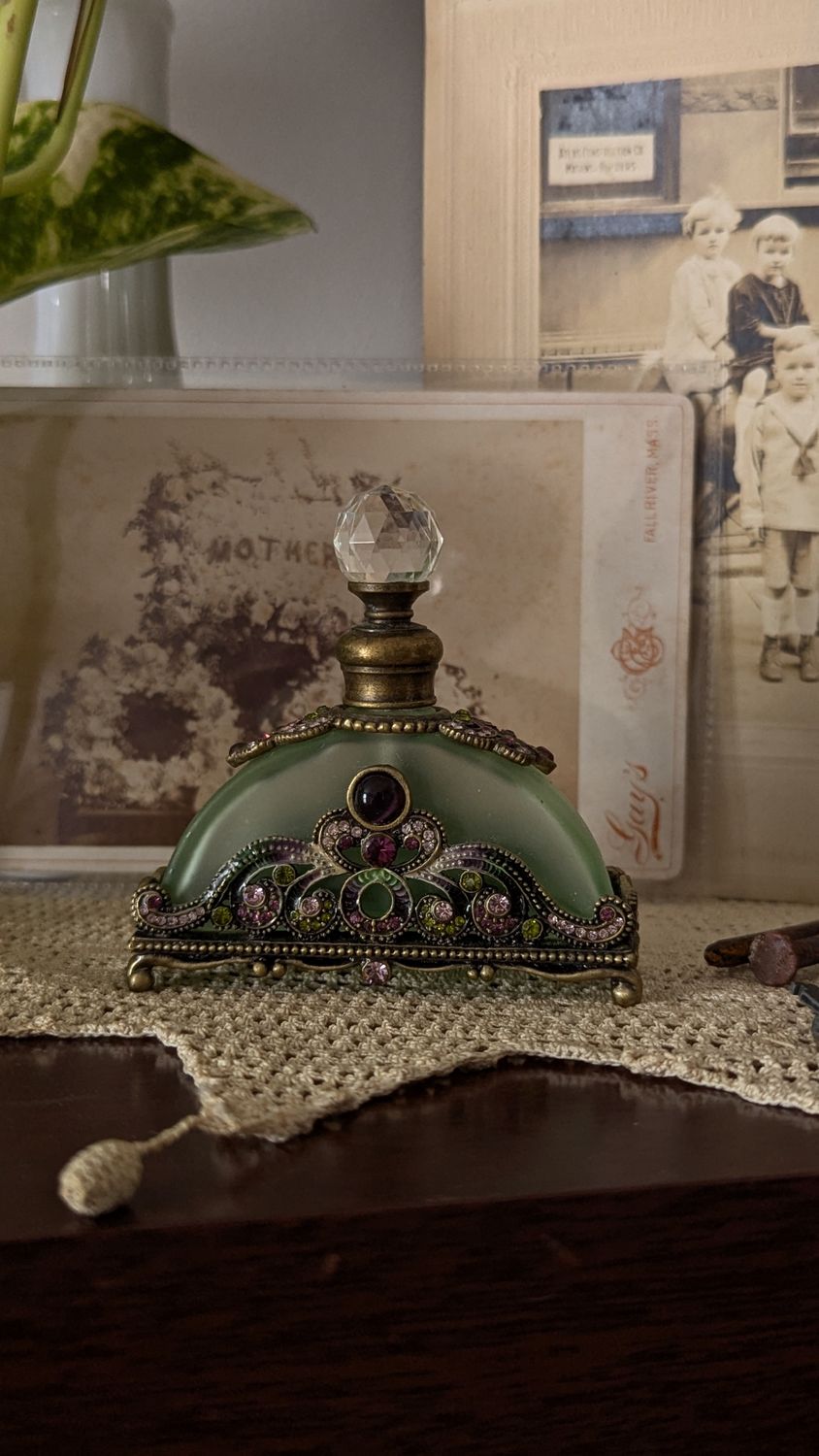 Green ornate perfume bottle oriental oil