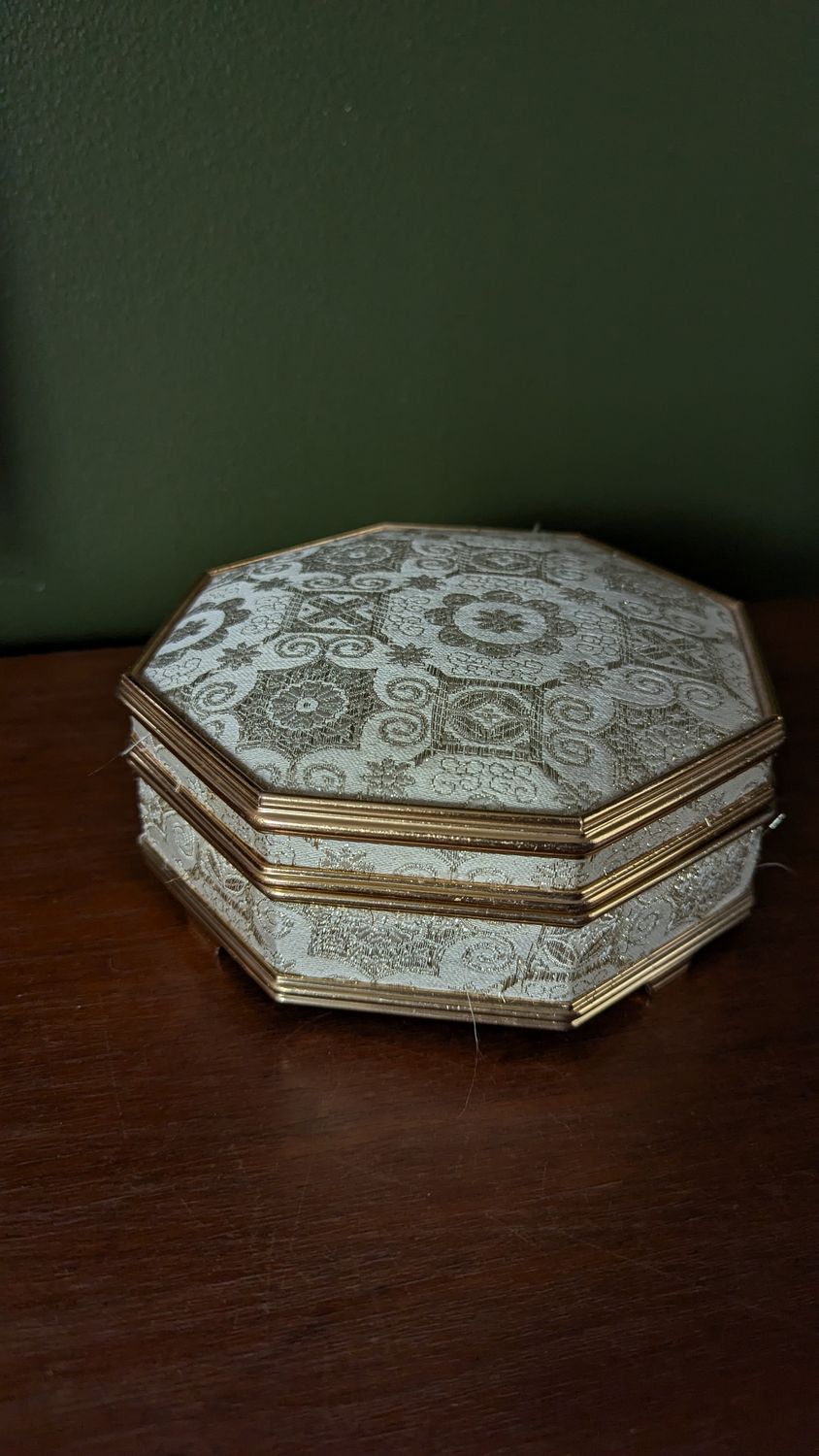 Octogonal fabric covered with yellow interior jewelry box