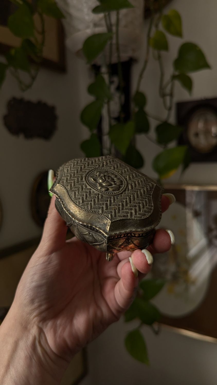 Small metal jewelry box wirh red lining and rose detail