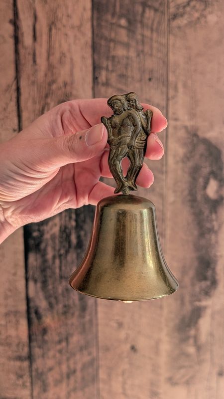 Women brass bell witch altar