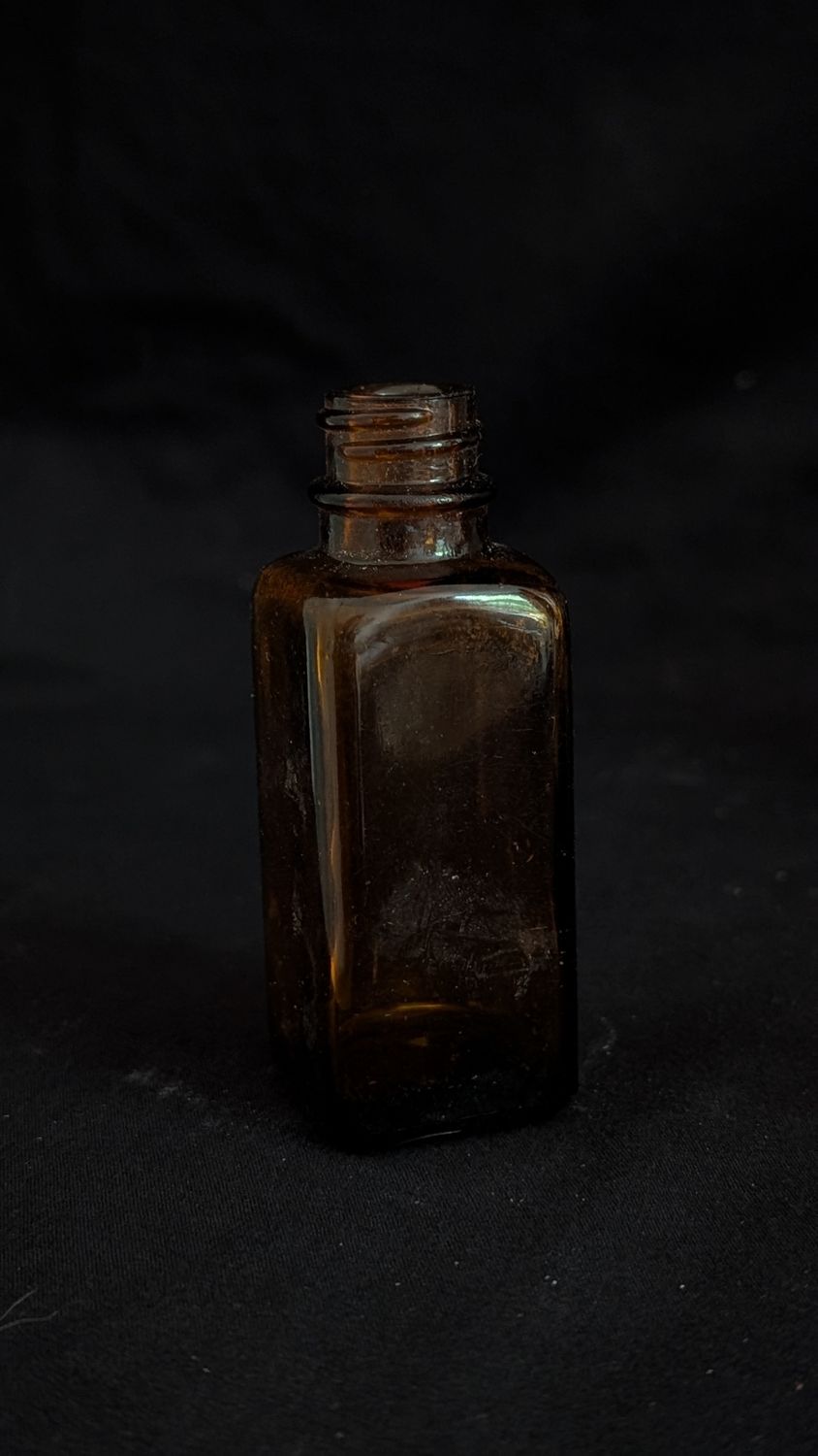 Small vintage amber colored bottle
