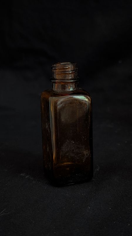 Small vintage amber colored bottle
