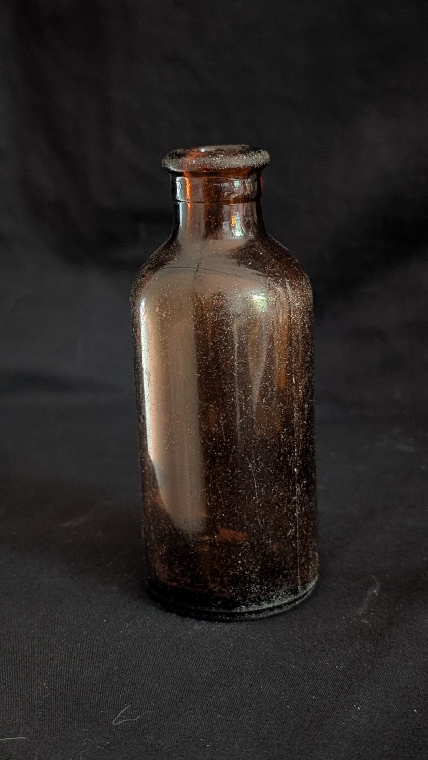 Round amber colored bottle vintage