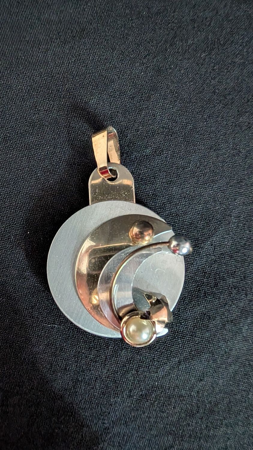 Intricate modern moon and star pendant with mirrored back