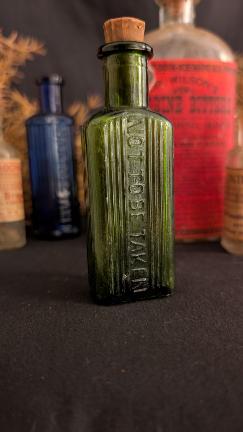 Green glass bottle poison not to be taken