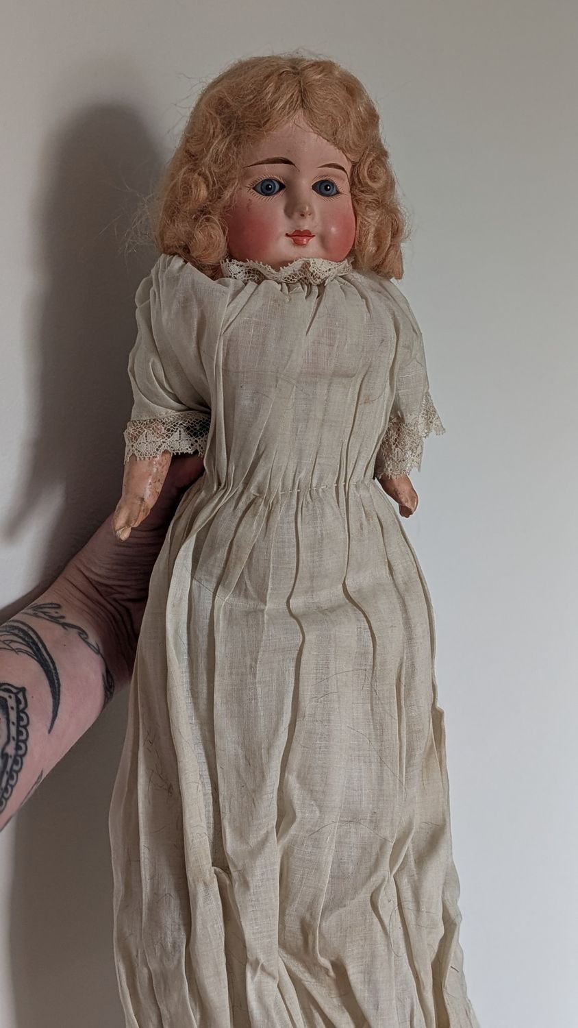 Antique doll with stray body