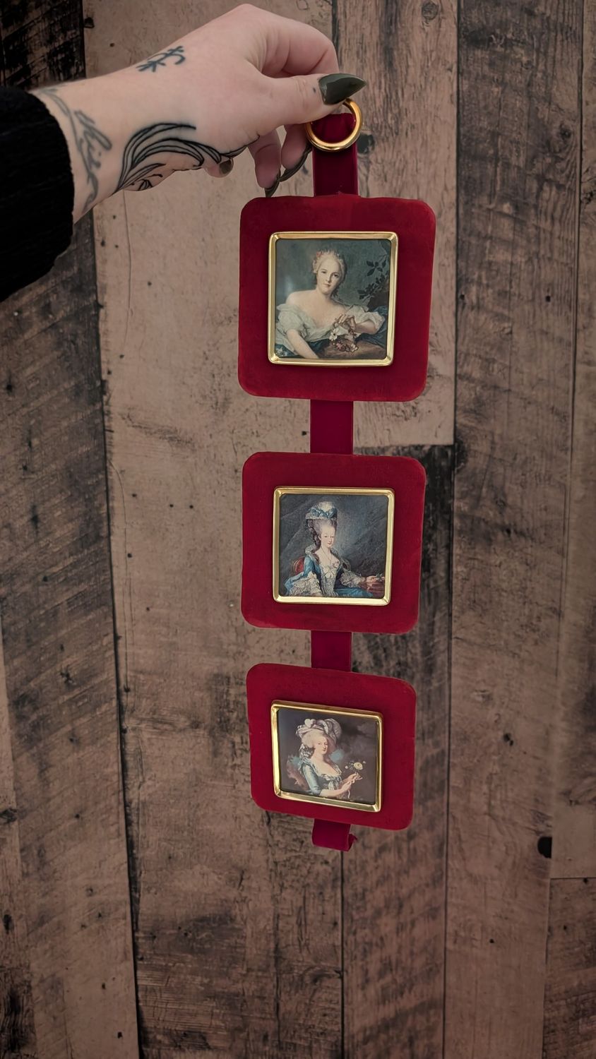 Set of three frames on red velvet square